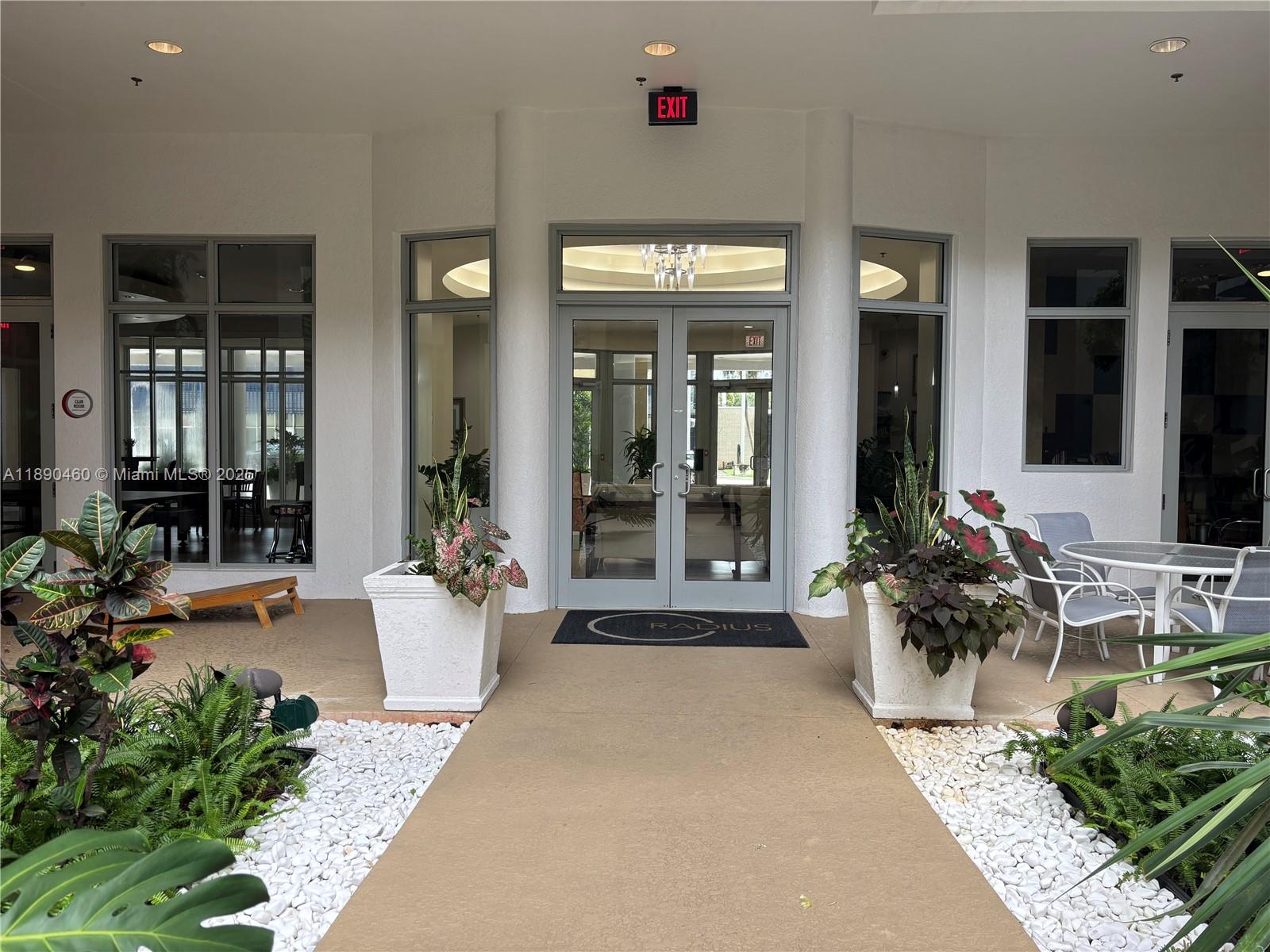 1830 Radius Drive, Unit 318 Hollywood, FL 33020 - Photo 46 of 47 a lobby with furniture and potted plants