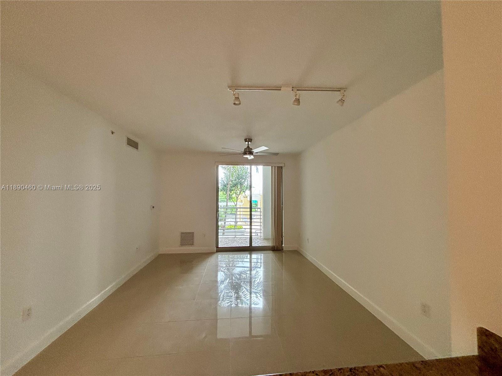 1830 Radius Drive, Unit 318 Hollywood, FL 33020 - Photo 7 of 47 an empty room with windows and cabinet