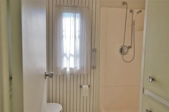 a living room with furniture and a view of kitchen