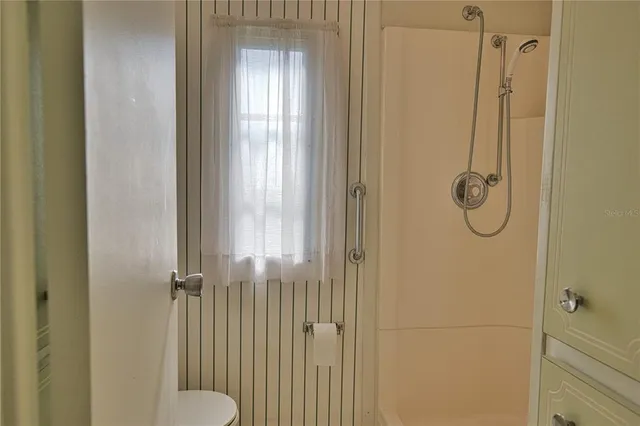 a living room with lots of furniture and a large window