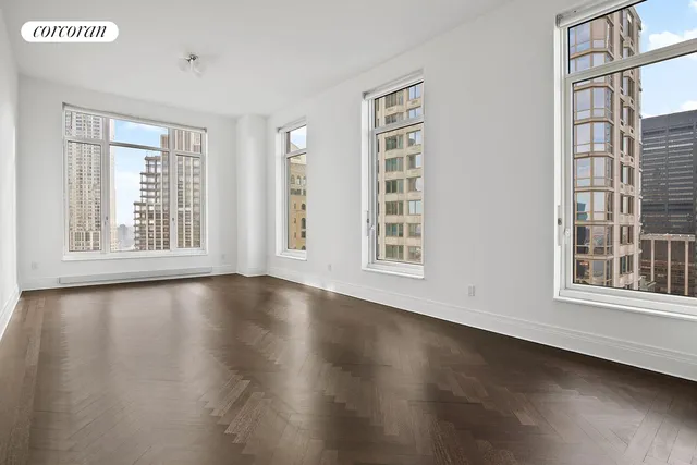 a living room with furniture large window and flower pot