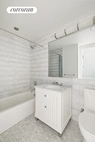 a spacious bathroom with a granite countertop sink mirror and shower