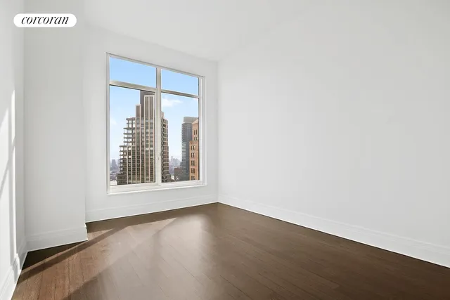 a bedroom with a bed a couch and a window