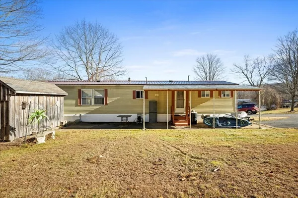a view of a house with swimming pool and sitting area