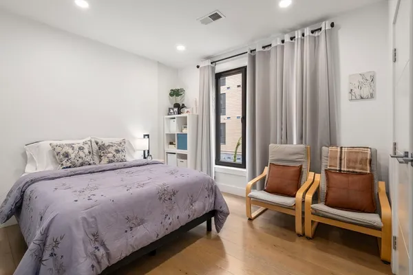 a bedroom with a bed and a chair