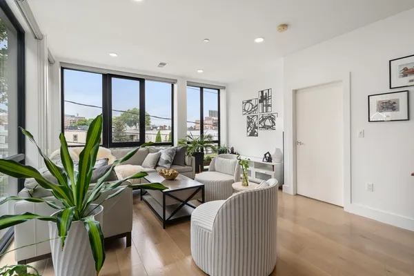 a living room with furniture and large windows