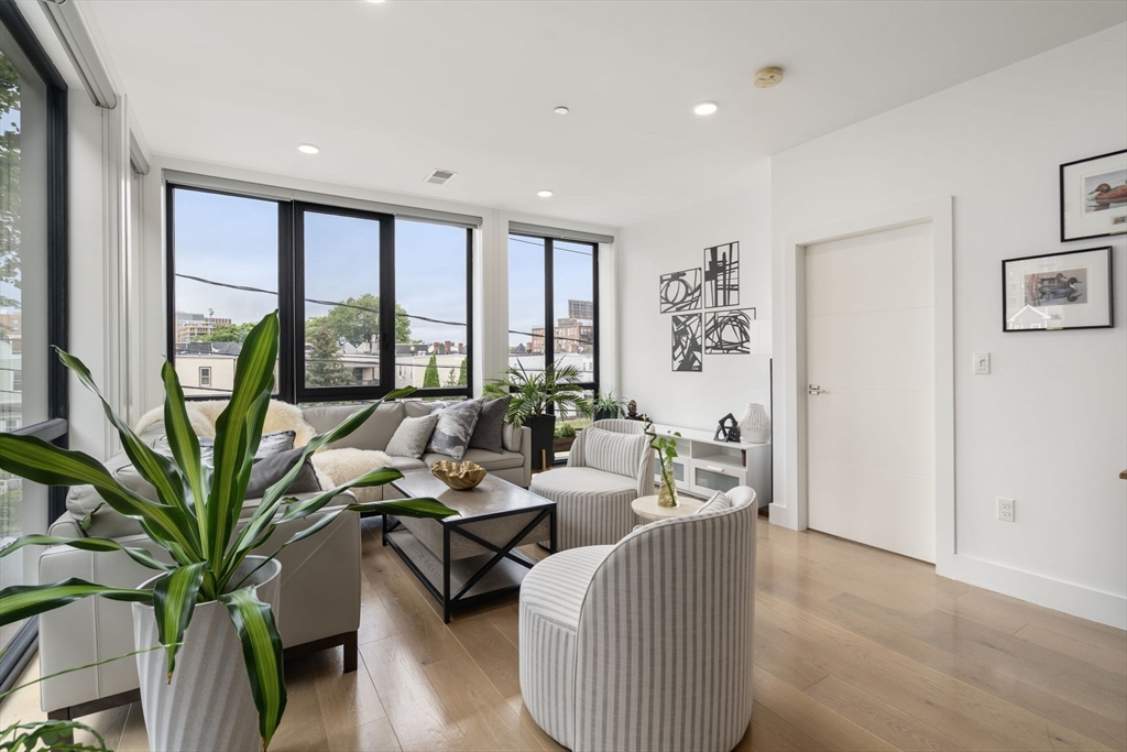 30 Penniman Road, Unit 201 Boston, MA 02134 - Photo 3 of 23 a living room with furniture and large windows