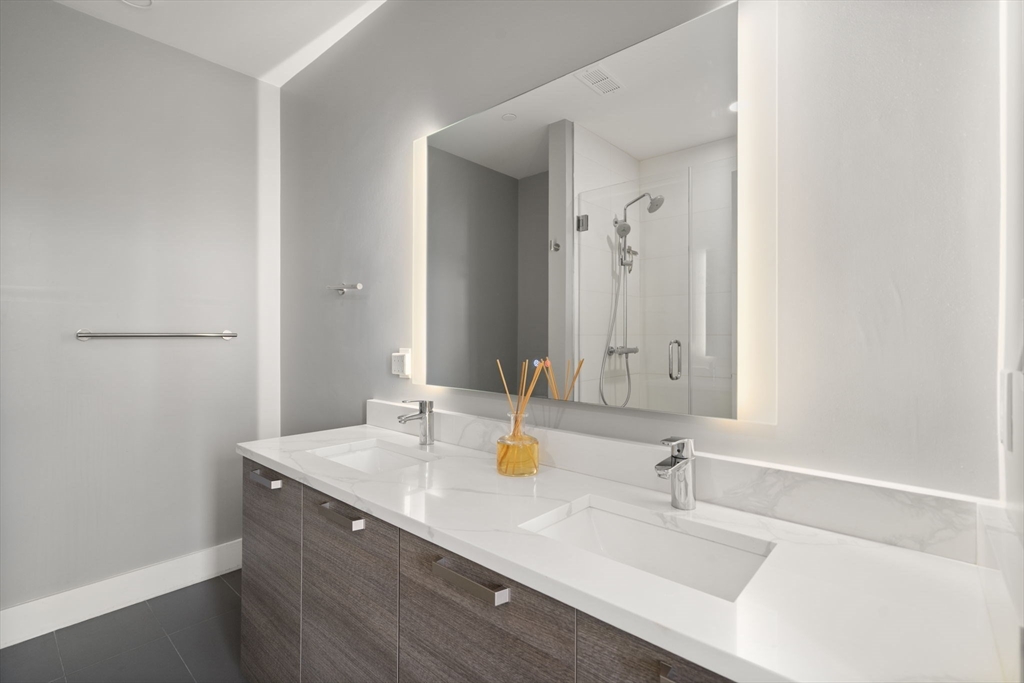 30 Penniman Road, Unit 201 Boston, MA 02134 - Photo 10 of 23 a bathroom with a sink and a mirror