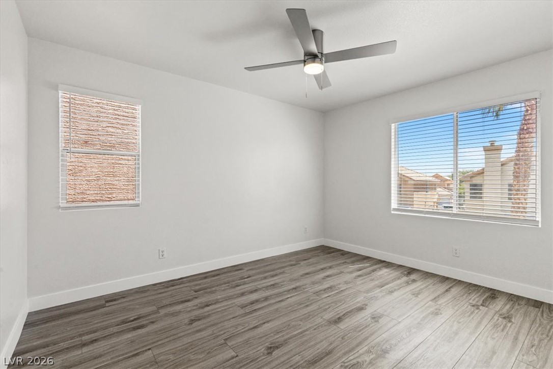 1412 Beaver Spring Street Las Vegas, NV 89128 - Photo 16 of 20 Well-lit living space with modern flooring and a contemporary ceiling fan for comfort.