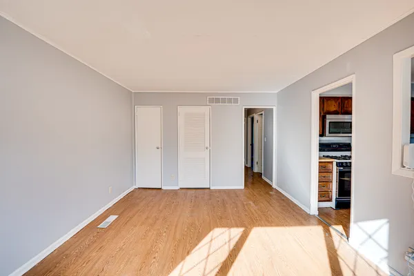 a view of a room with wooden floor and closet