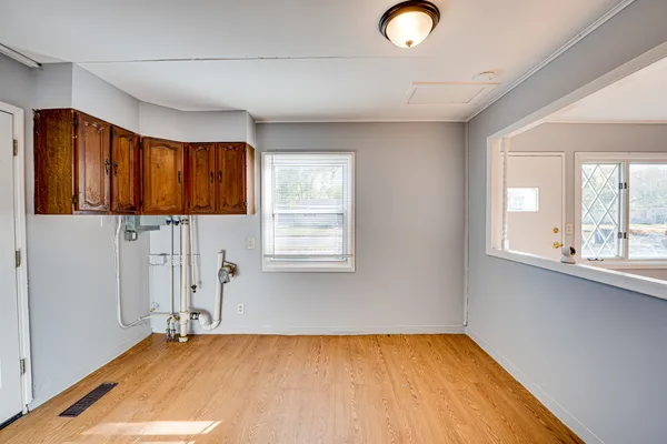 a view of a livingroom with wooden floor and window