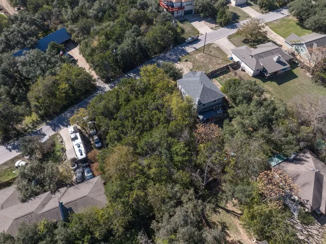 an aerial view of residential house with green space