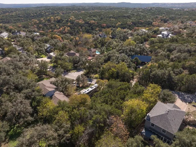 an aerial view of house with yard and mountain view in back