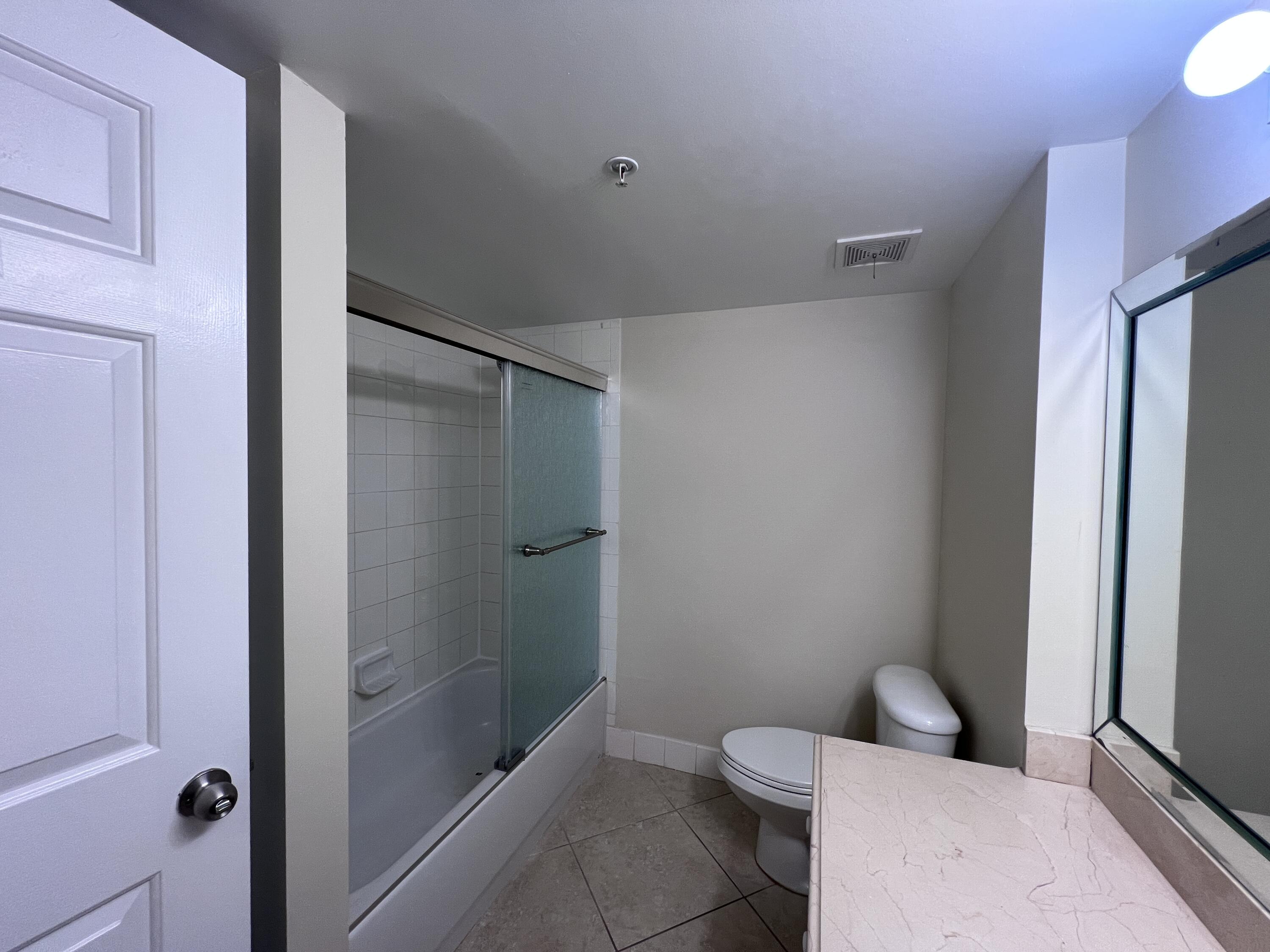 284 Village Boulevard, Unit 9202 Tequesta, FL 33469 - Photo 11 of 16 a bathroom with a toilet and shower