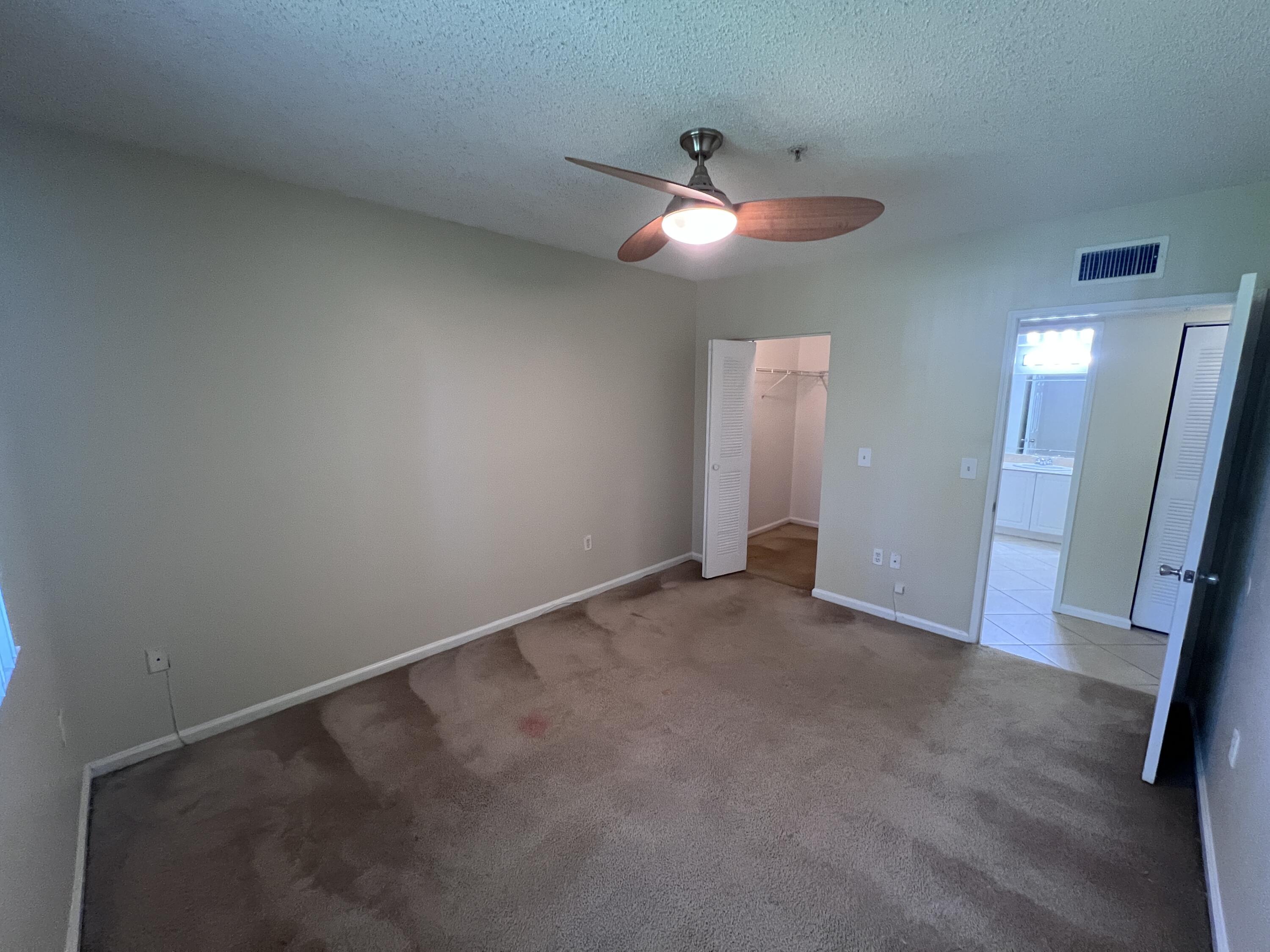 284 Village Boulevard, Unit 9202 Tequesta, FL 33469 - Photo 13 of 16 an empty room with closet and a chandelier fan