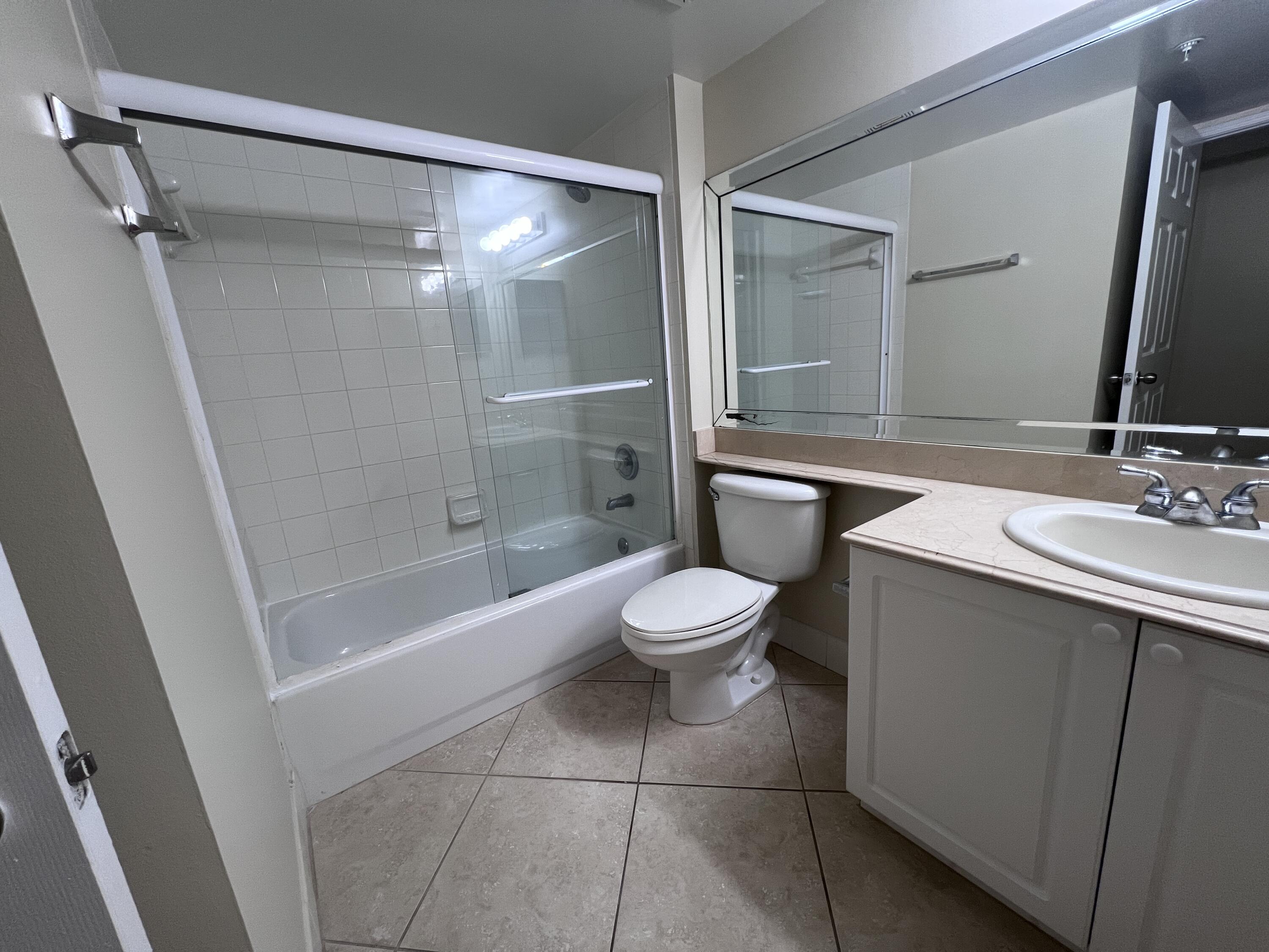 284 Village Boulevard, Unit 9202 Tequesta, FL 33469 - Photo 15 of 16 a bathroom with a bathtub shower sink vanity and toilet
