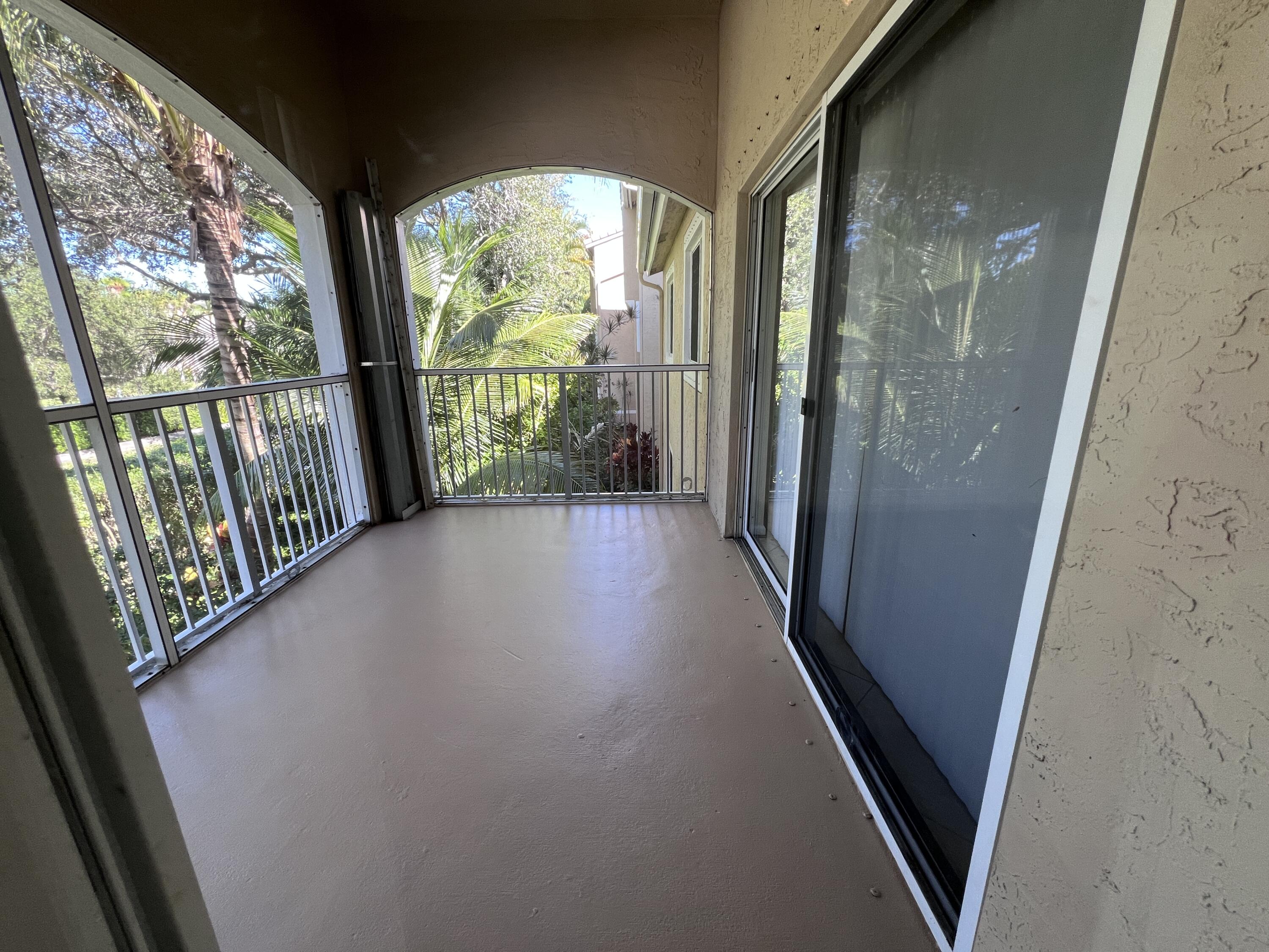 284 Village Boulevard, Unit 9202 Tequesta, FL 33469 - Photo 4 of 16 a view of a glass door with a porch