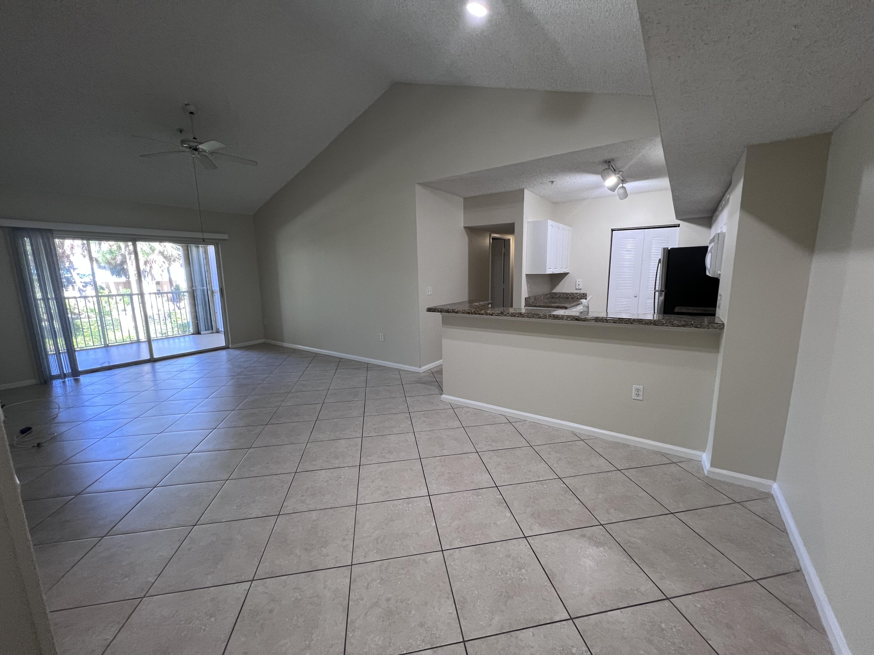 284 Village Boulevard, Unit 9202 Tequesta, FL 33469 - Photo 5 of 16 a view of a kitchen with a sink and a fireplace