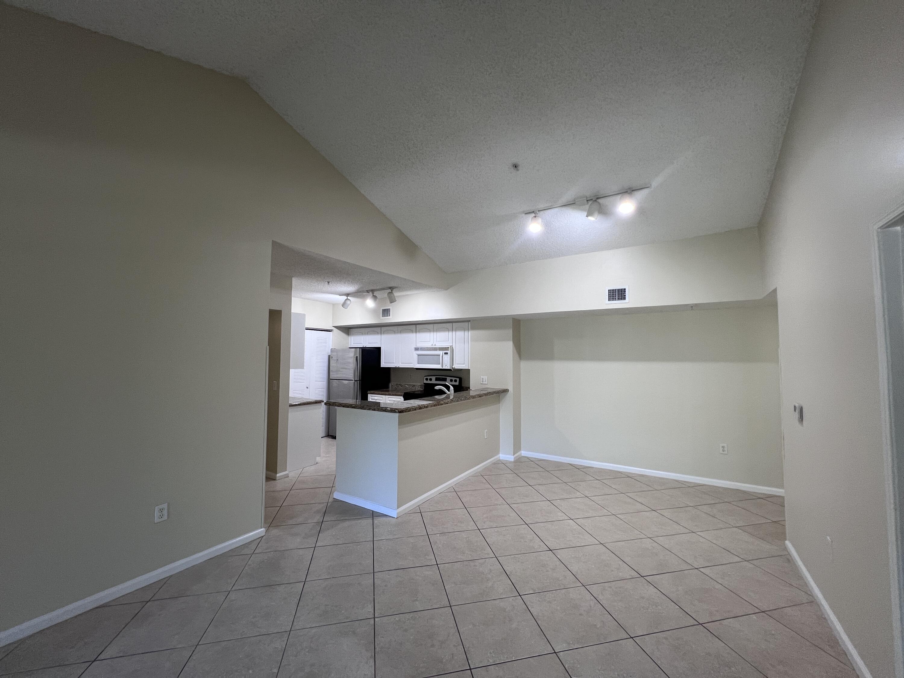 284 Village Boulevard, Unit 9202 Tequesta, FL 33469 - Photo 6 of 16 a kitchen with a sink a stove and cabinets