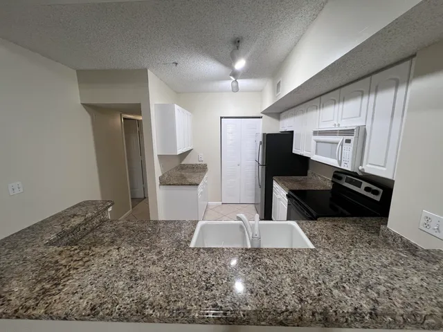 a view of a refrigerator in kitchen and living room