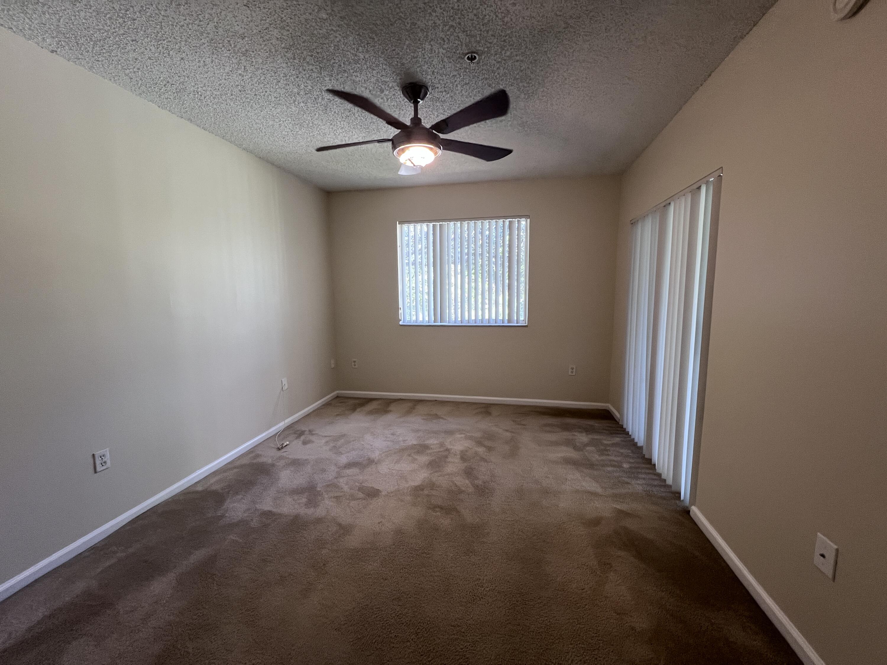 284 Village Boulevard, Unit 9202 Tequesta, FL 33469 - Photo 10 of 16 an empty room with a window and a fan
