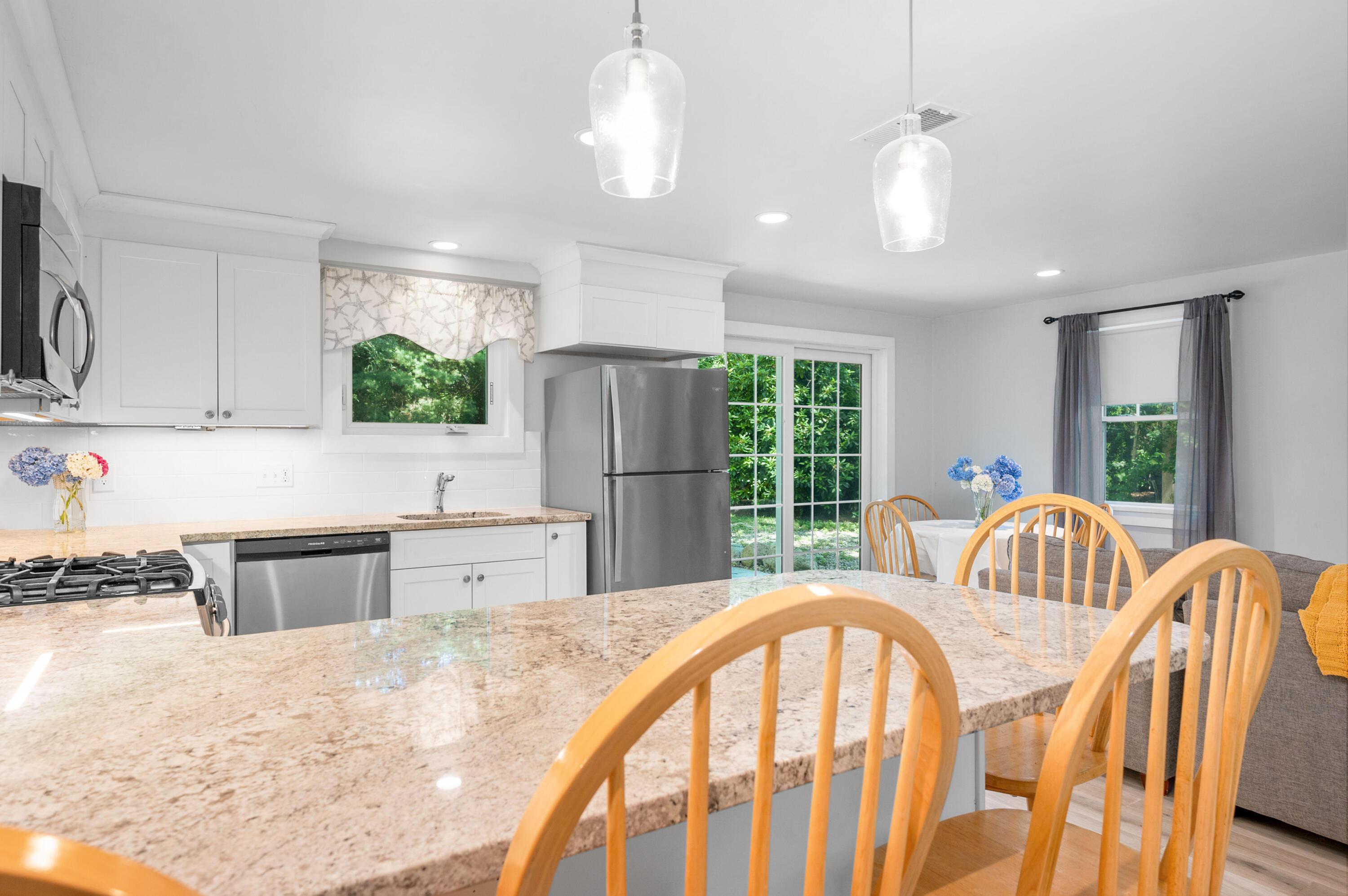 36 Riverside Road Mashpee, MA 02649 - Photo 11 of 48 a very nice looking kitchen with granite countertop a stove a sink a refrigerator dining table and chairs