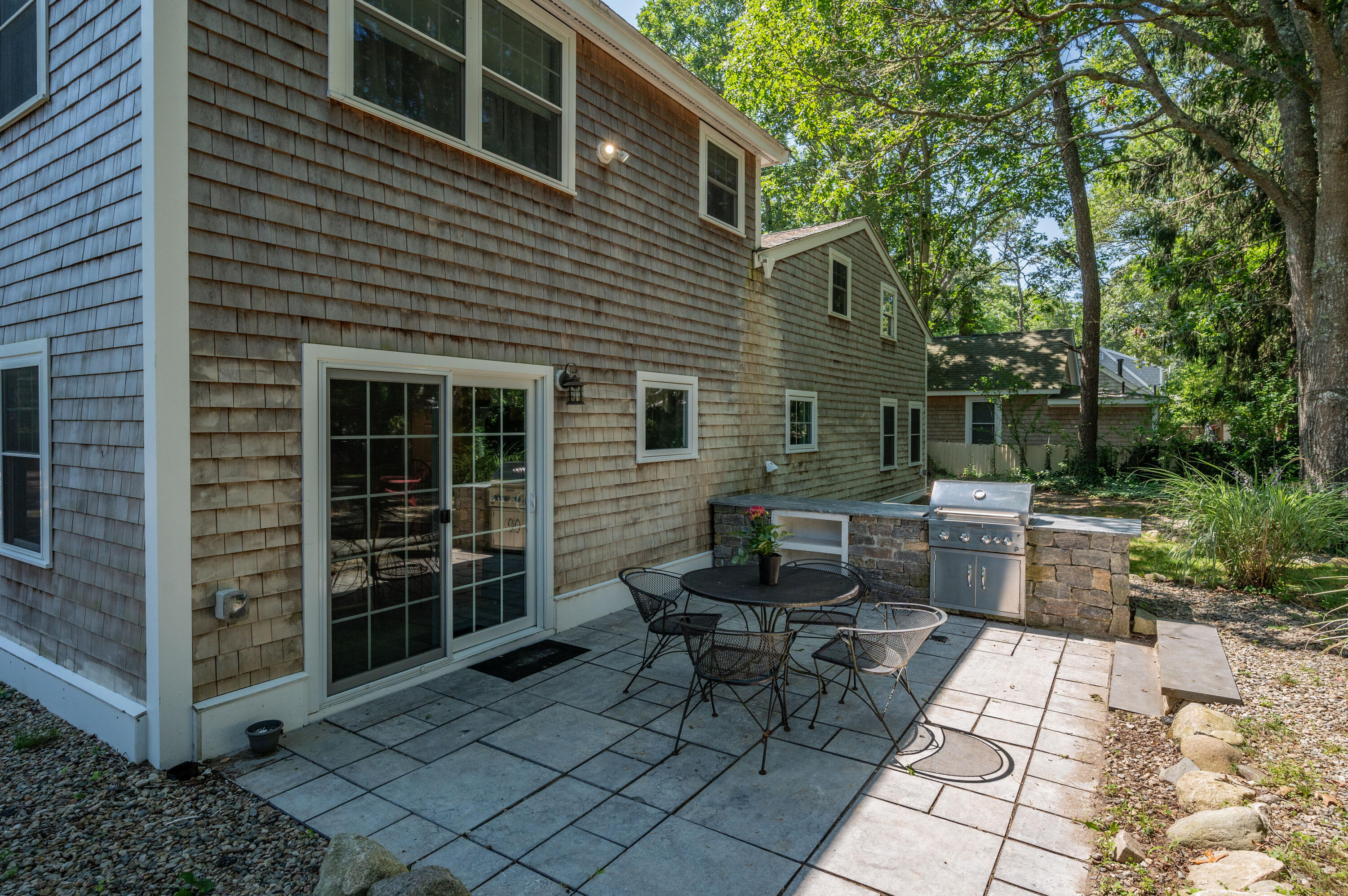 36 Riverside Road Mashpee, MA 02649 - Photo 27 of 48 a backyard of a house with outdoor seating