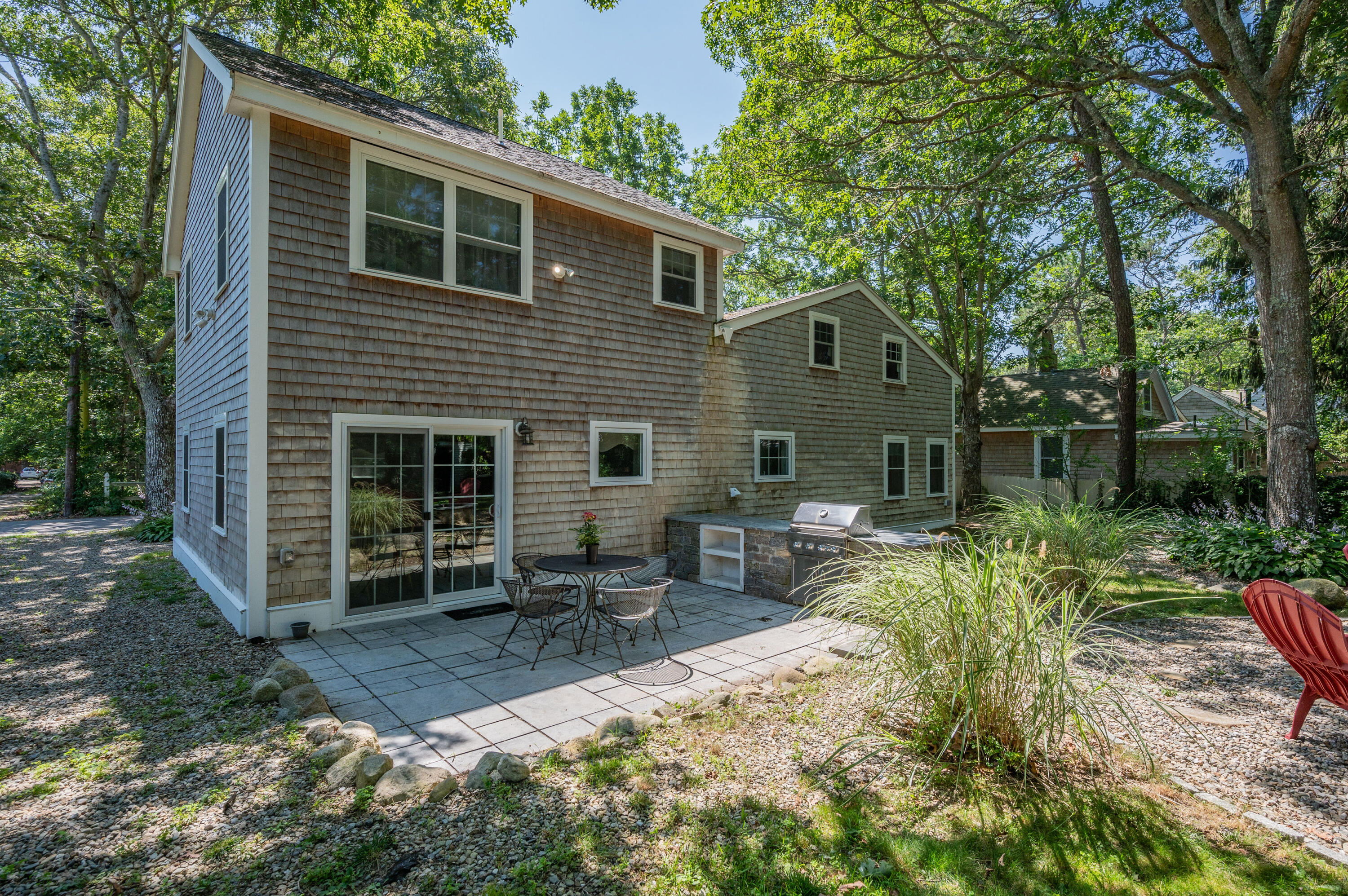 36 Riverside Road Mashpee, MA 02649 - Photo 28 of 48 a backyard of a house with outdoor seating