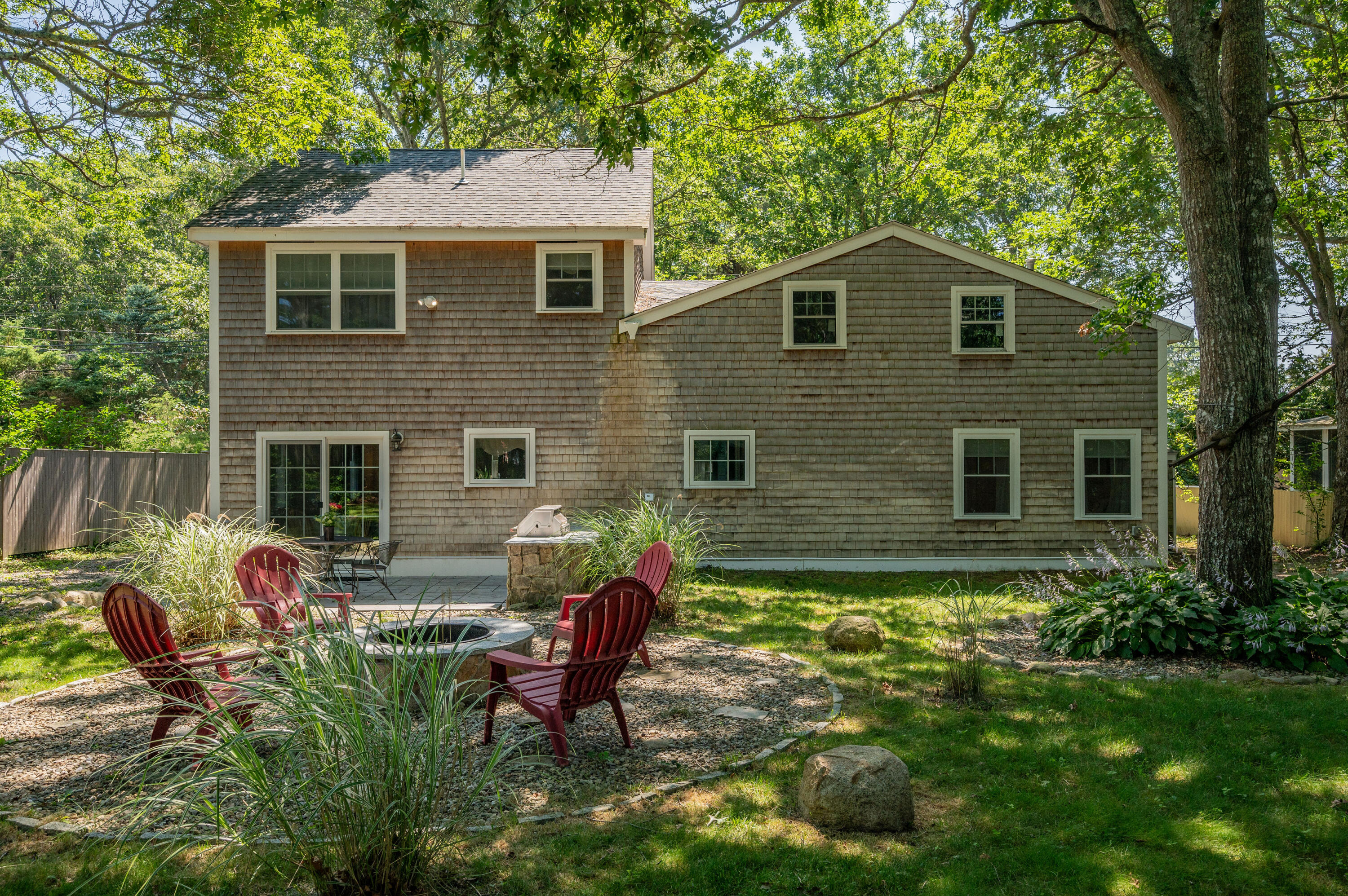 36 Riverside Road Mashpee, MA 02649 - Photo 31 of 48 a backyard of a house with seating space