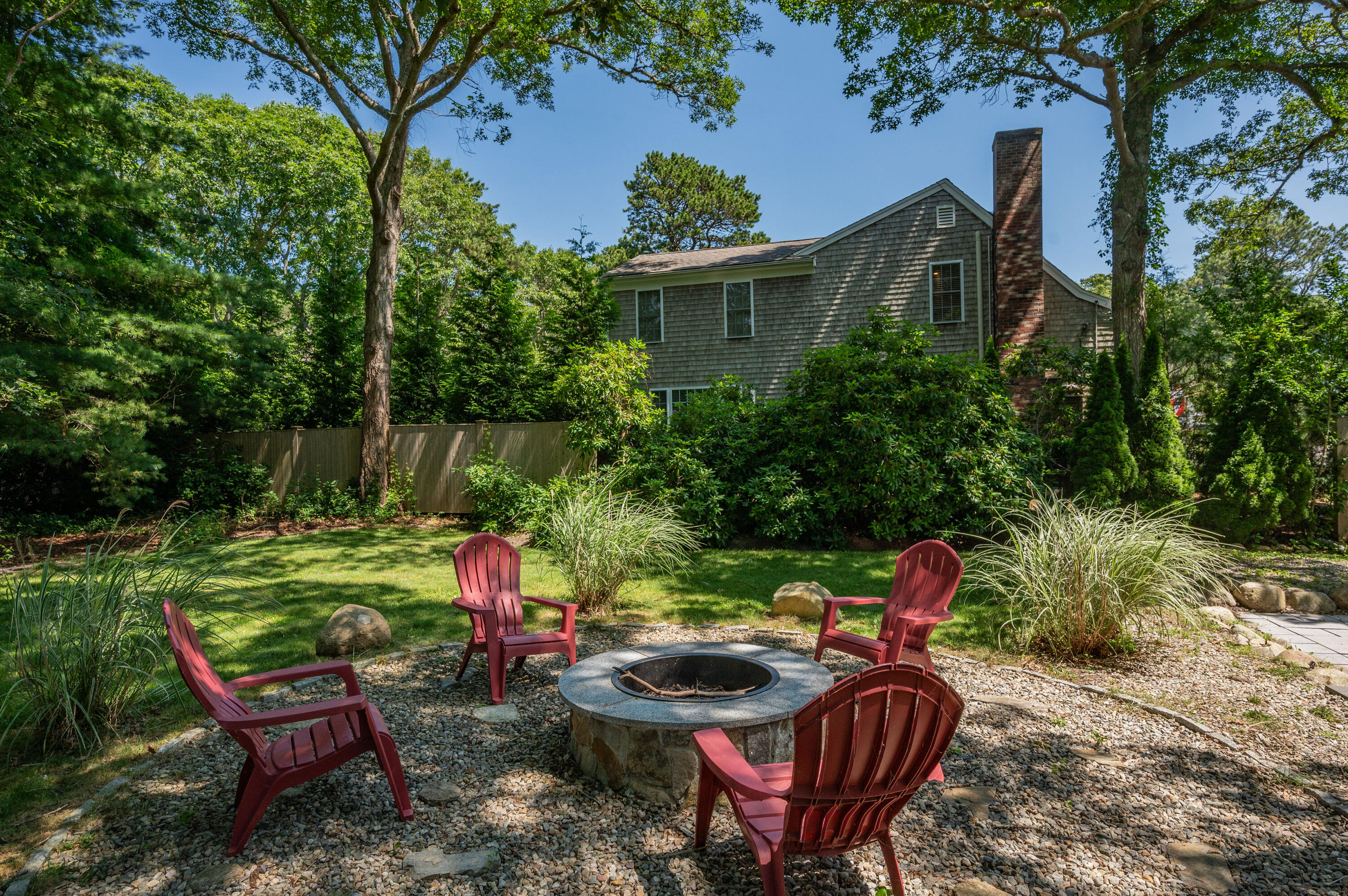 36 Riverside Road Mashpee, MA 02649 - Photo 33 of 48 a backyard of a house with table and chairs