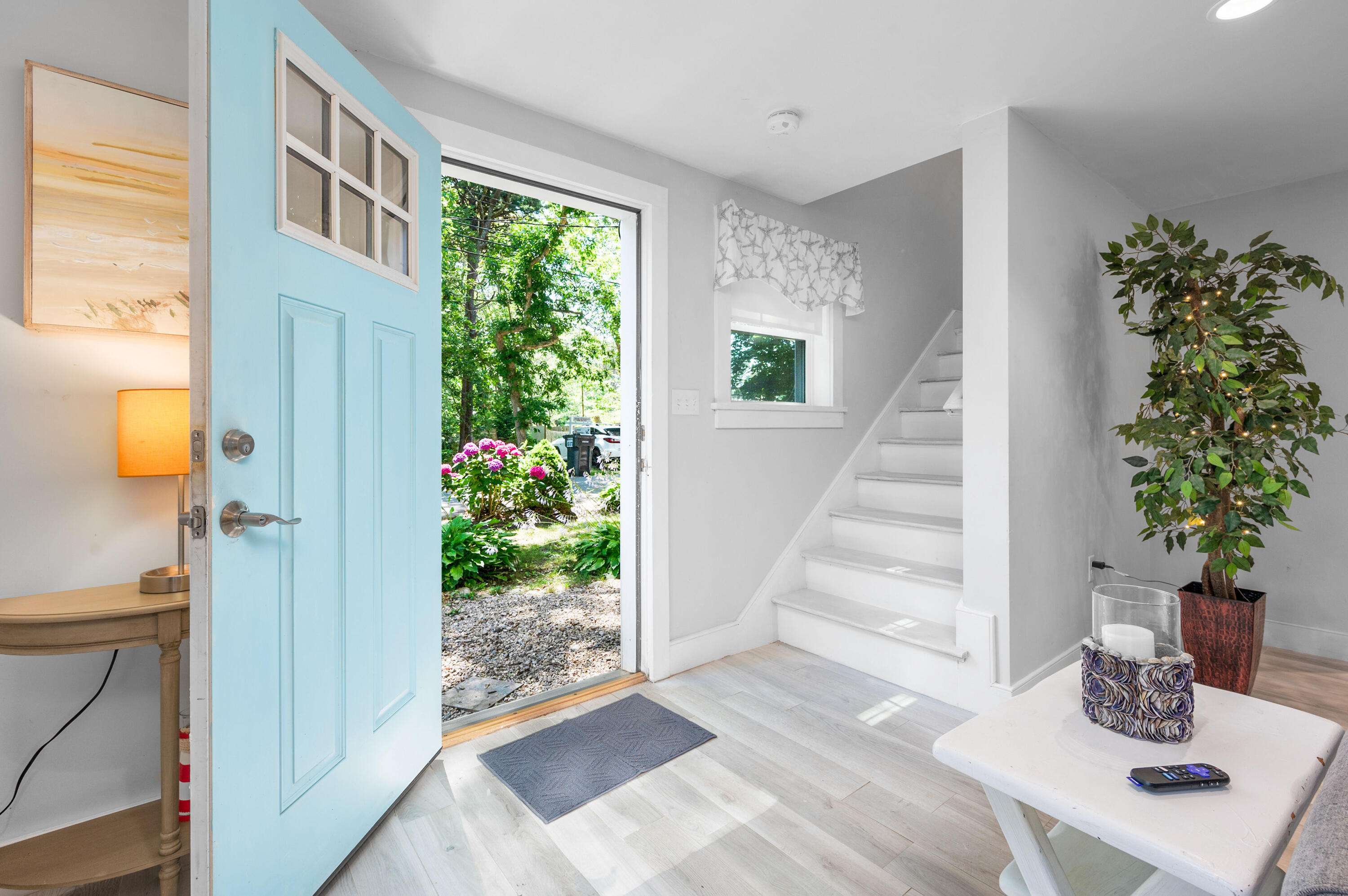 36 Riverside Road Mashpee, MA 02649 - Photo 5 of 48 a view of an entryway with wooden floor and front door
