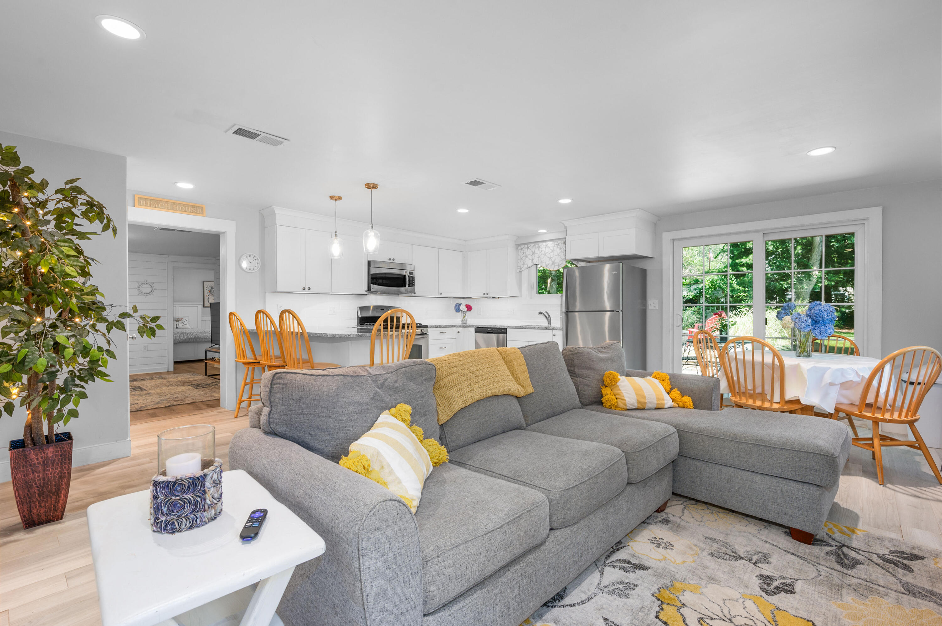 36 Riverside Road Mashpee, MA 02649 - Photo 6 of 48 a living room with furniture kitchen view and a large window