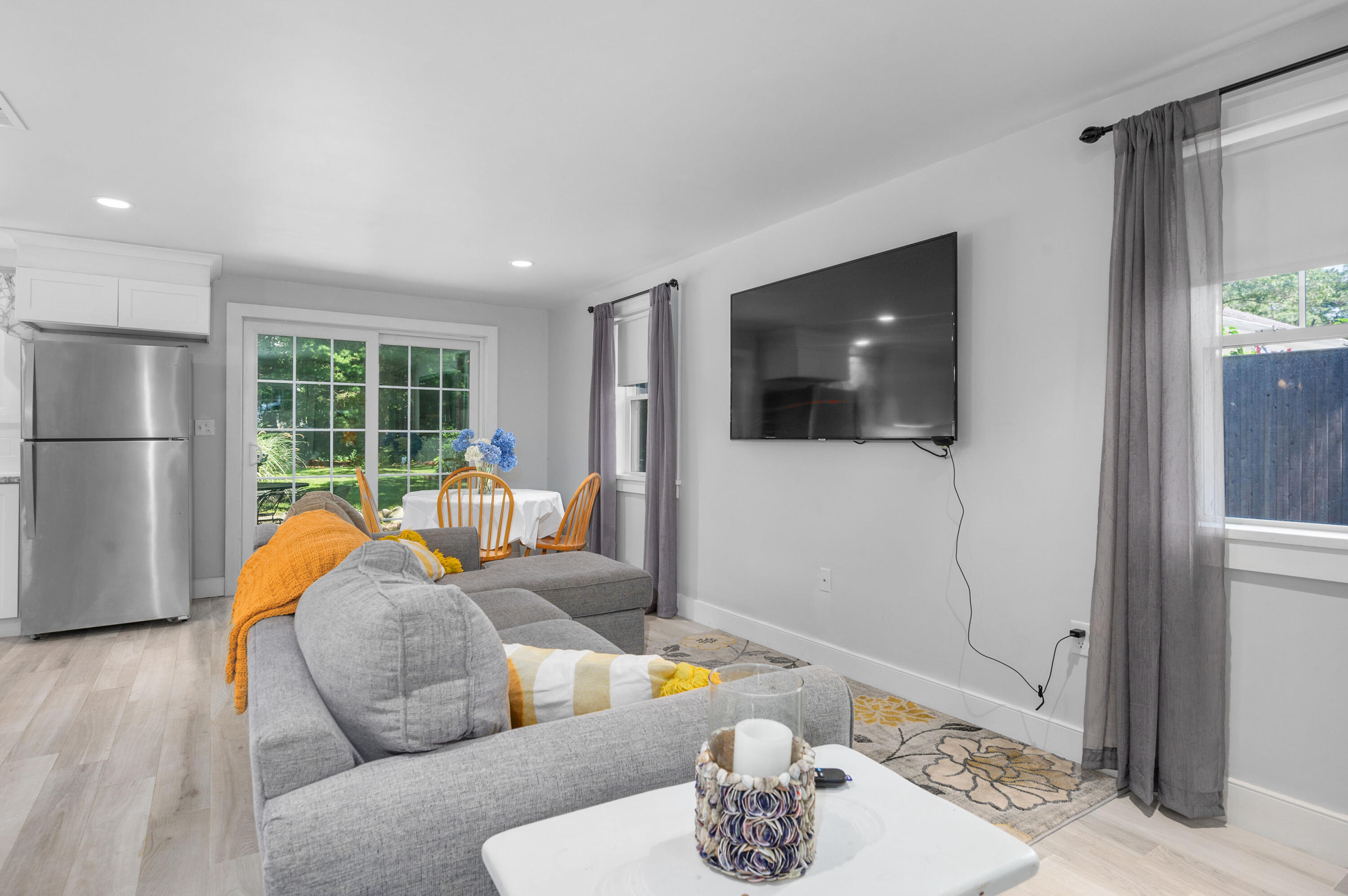 36 Riverside Road Mashpee, MA 02649 - Photo 8 of 48 a living room with furniture and a flat screen tv