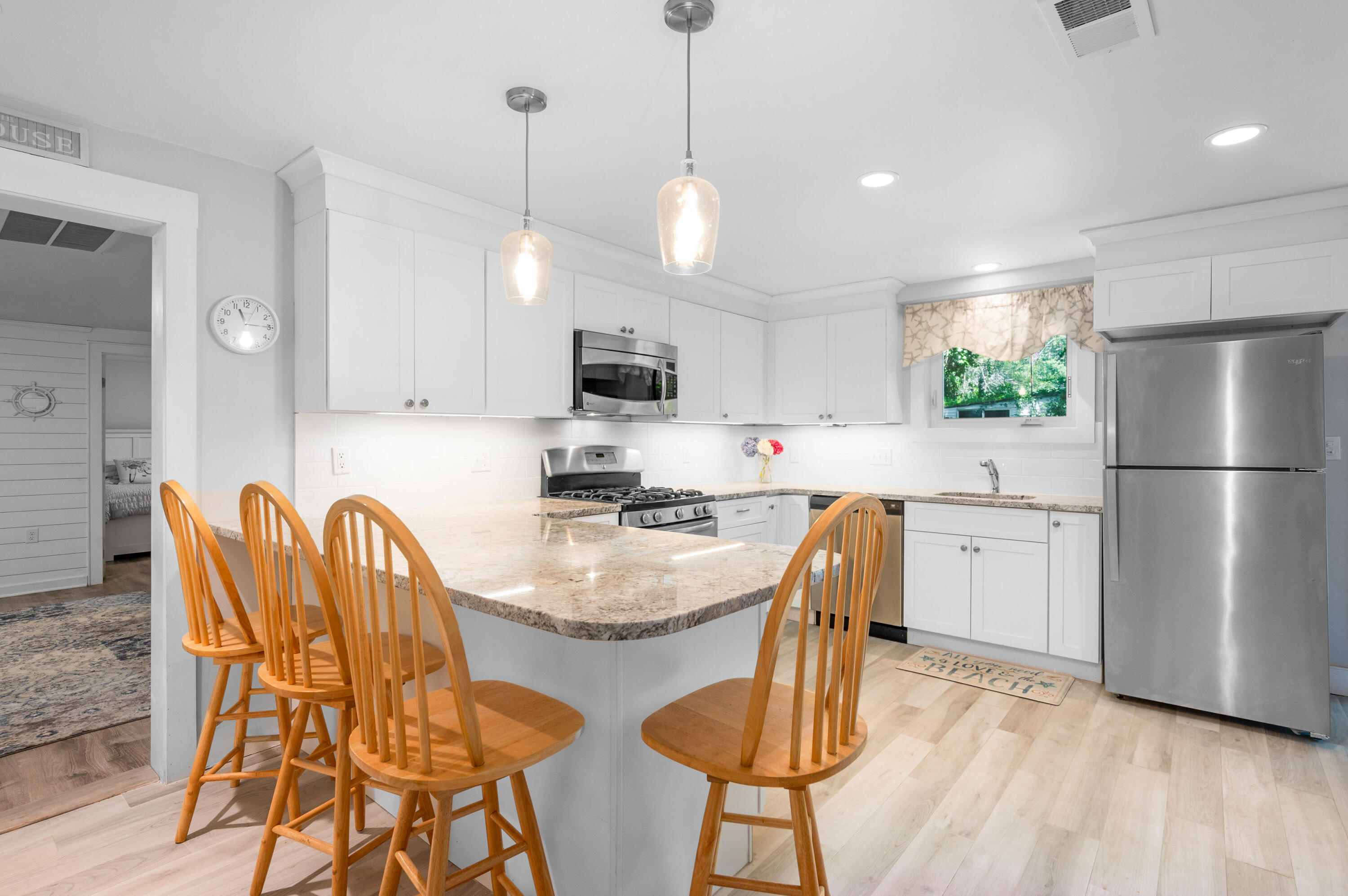 36 Riverside Road Mashpee, MA 02649 - Photo 10 of 48 a kitchen with stainless steel appliances granite countertop a dining table chairs refrigerator and microwave