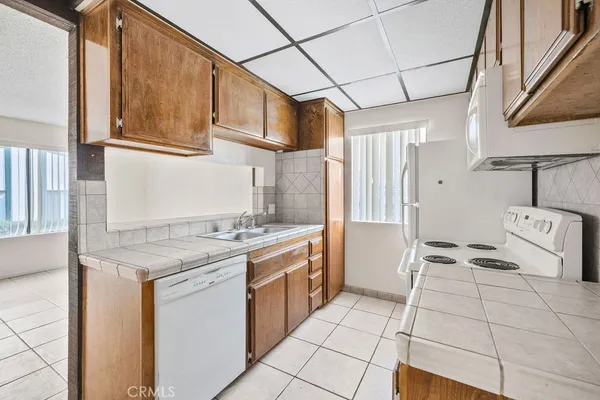 a kitchen with a sink a stove and cabinets