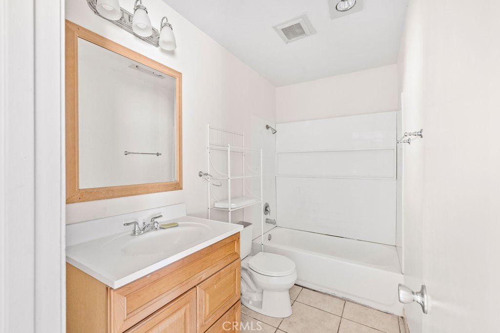 1735 East Washington Street, Unit F14 Colton, CA 92324 - Photo 18 of 26 a bathroom with a sink toilet and shower