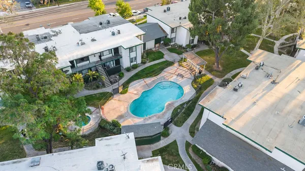 an aerial view of a house with a yard and trees