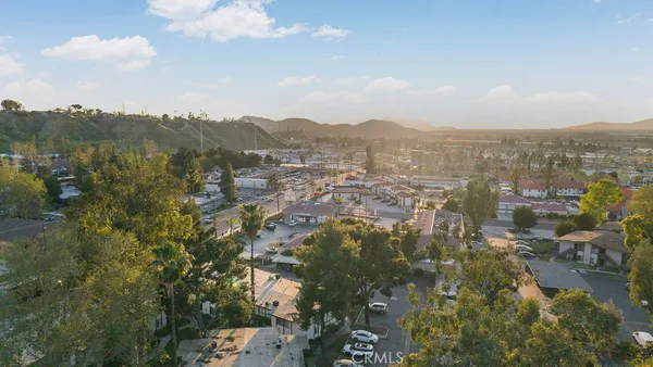 an aerial view of a house with a yard