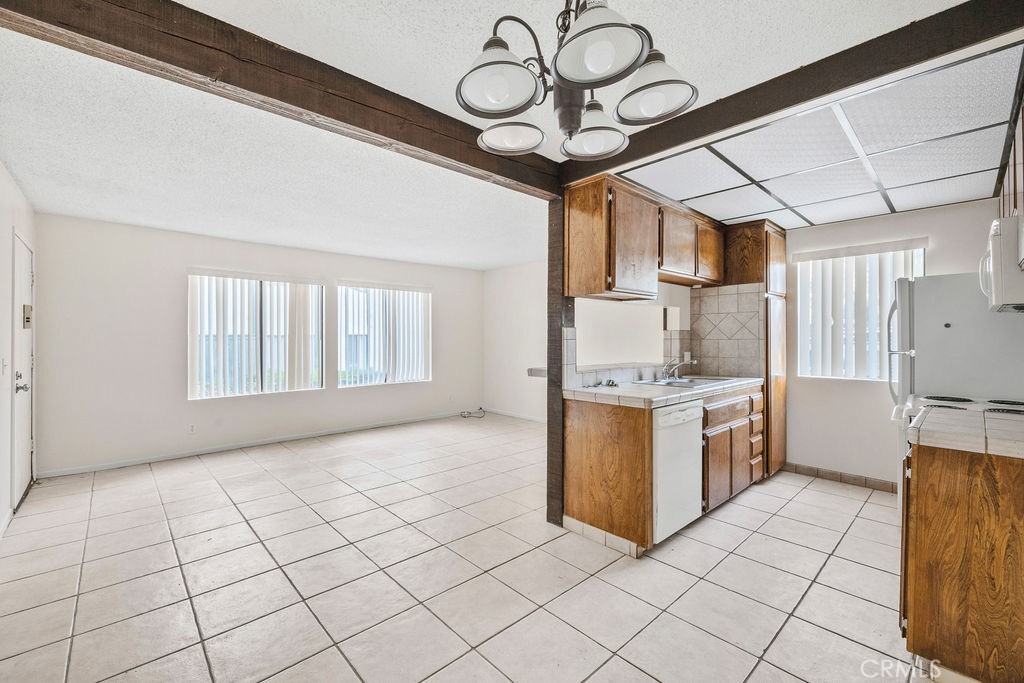 1735 East Washington Street, Unit F14 Colton, CA 92324 - Photo 10 of 26 a large kitchen with cabinets and stainless steel appliances