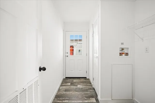 a view of a hallway with wooden floor and entryway