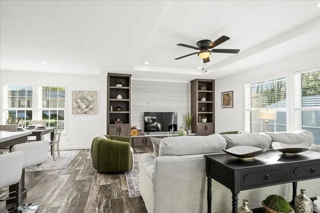 a living room with furniture a fireplace and a chandelier