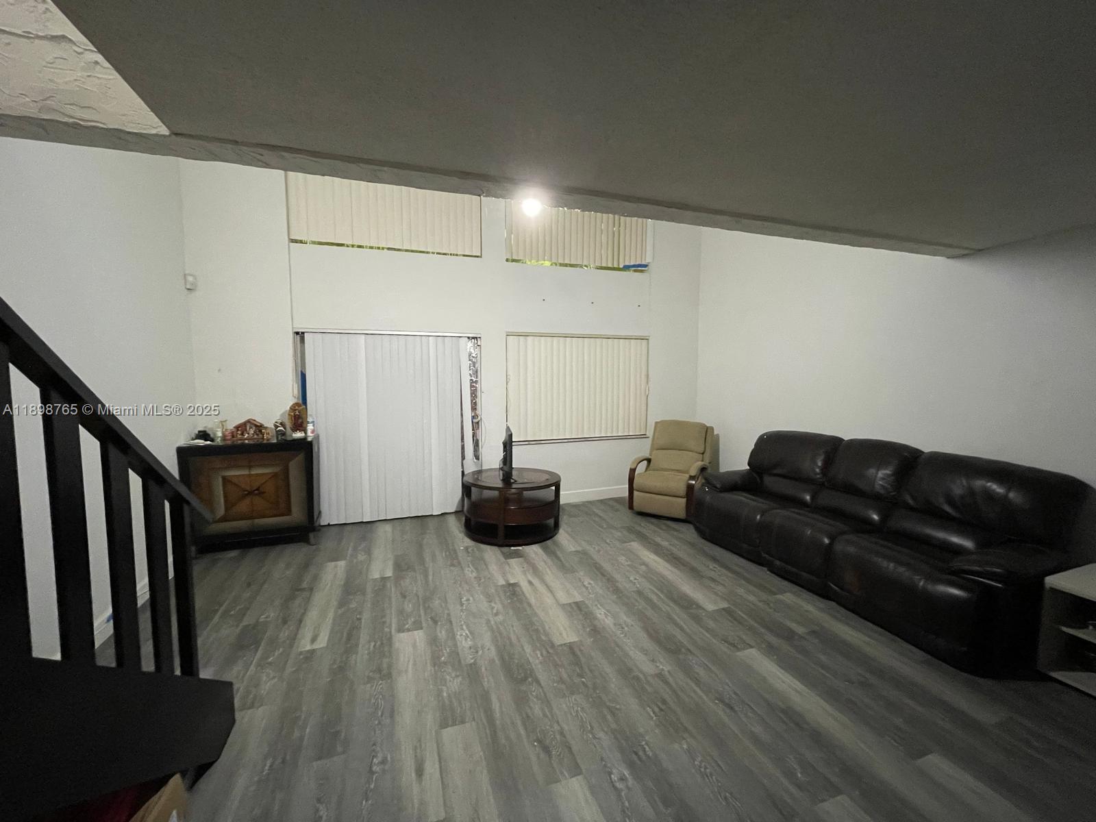 18101 Northwest 68th Avenue, Unit E201 Hialeah, FL 33015 - Photo 5 of 15 a living room with furniture