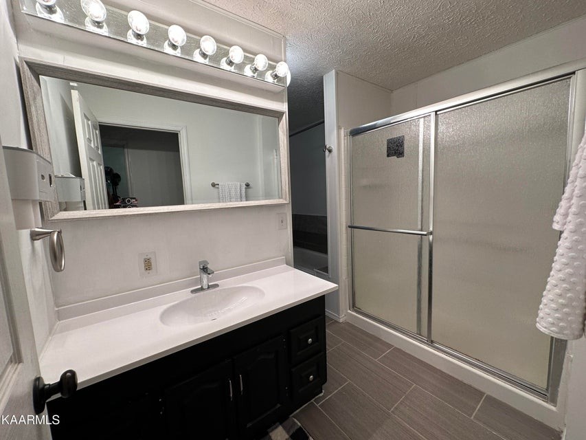 291 Dynatex Road Sunbright, TN 37872 - Photo 16 of 23 a bathroom with a sink vanity and a mirror