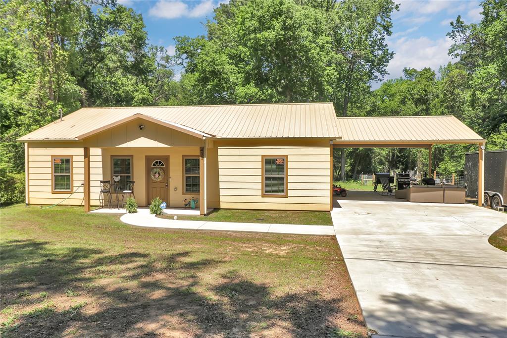a front view of a house with a garden and patio