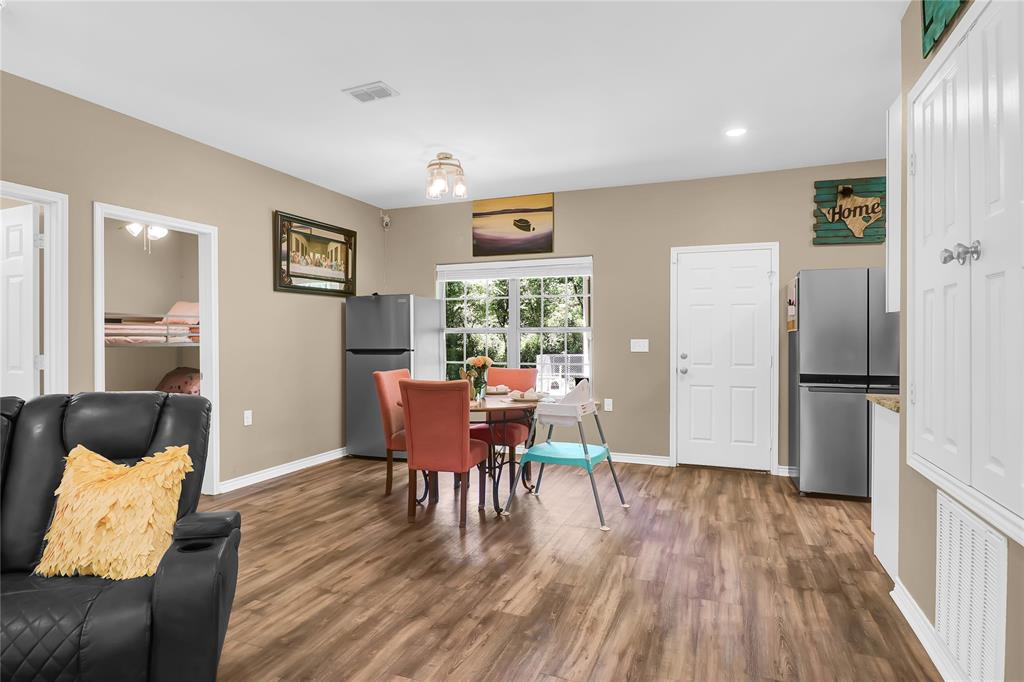 411 Johnson Street Longview, TX 75602 - Photo 12 of 25 a dining room with furniture and wooden floor