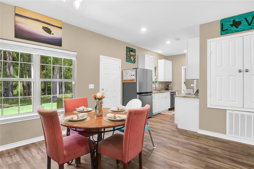 411 Johnson Street Longview, TX 75602 - Photo 14 of 25 a view of a dining room with furniture window and wooden floor