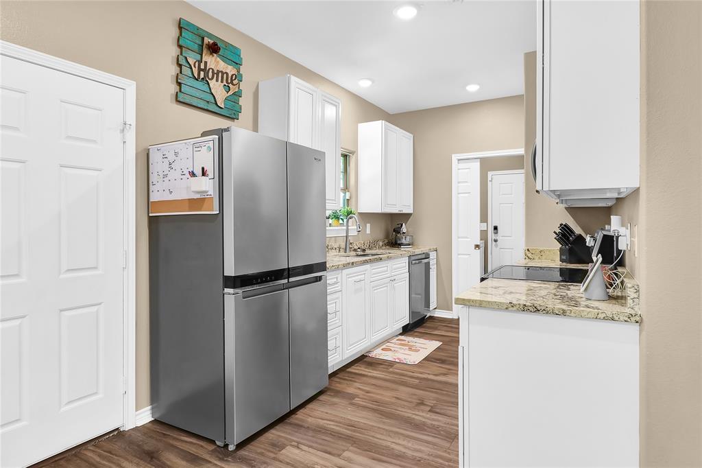411 Johnson Street Longview, TX 75602 - Photo 15 of 25 a white refrigerator freezer sitting inside of a kitchen