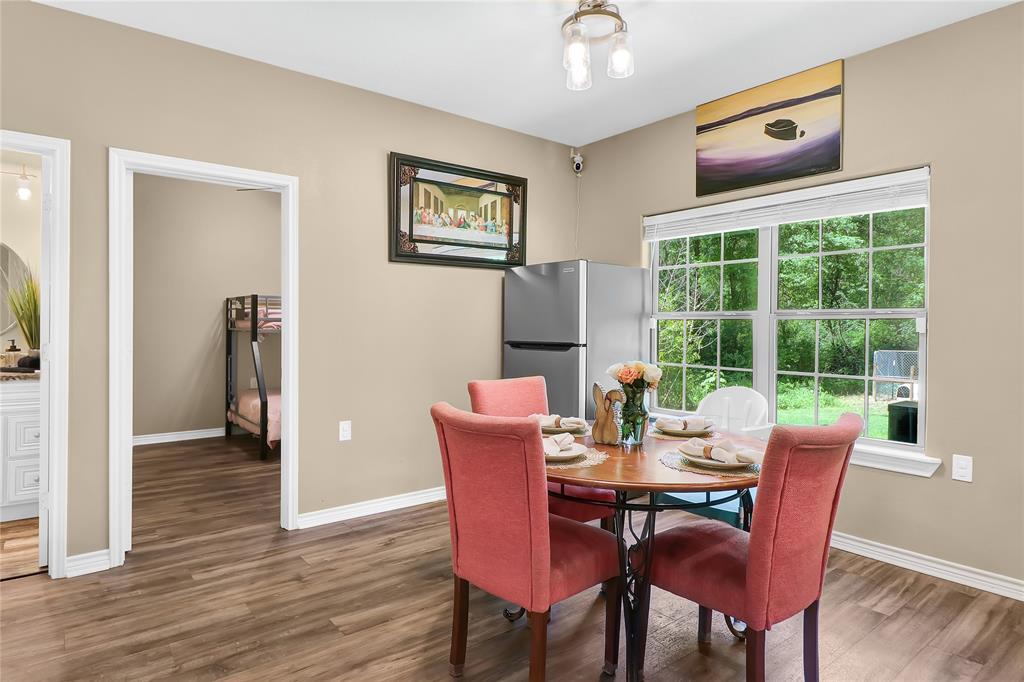 411 Johnson Street Longview, TX 75602 - Photo 17 of 25 a dining room with furniture and wooden floor