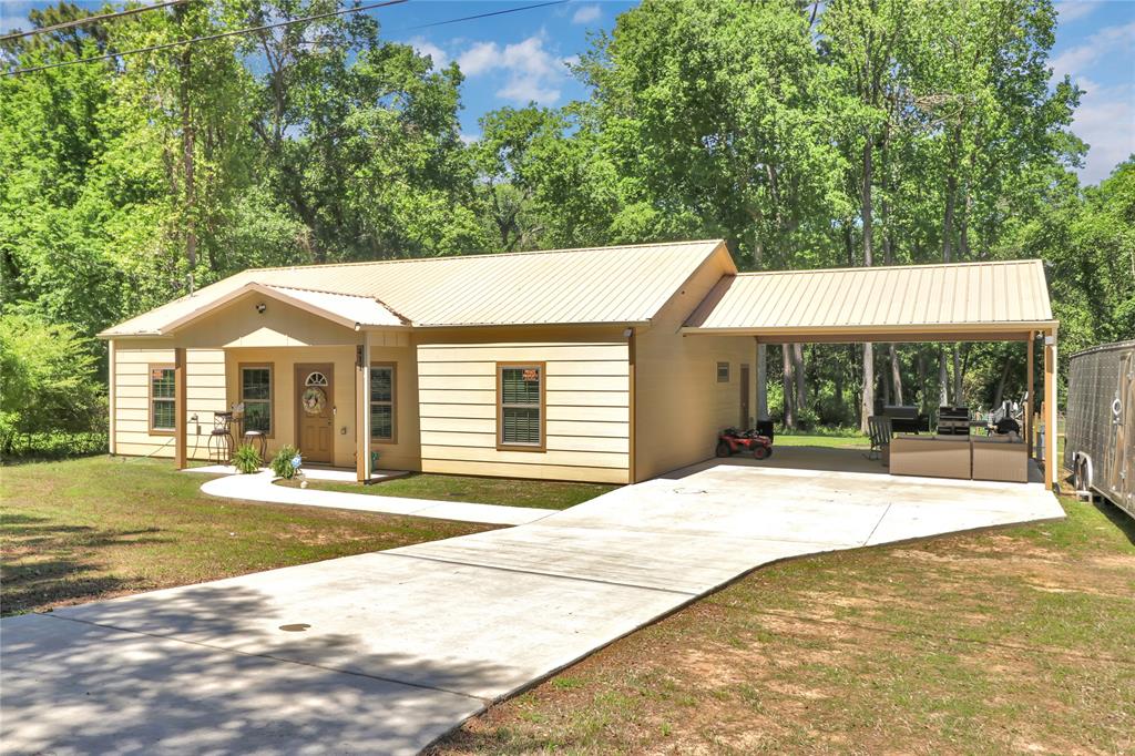 411 Johnson Street Longview, TX 75602 - Photo 2 of 25 a backyard of a house with yard and outdoor seating