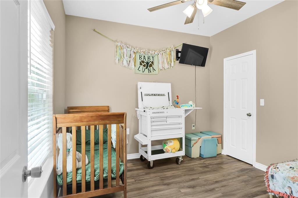 411 Johnson Street Longview, TX 75602 - Photo 22 of 25 a living room with furniture and a flat screen tv